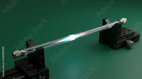 Glowing plasma discharge inside a glass vacuum tube fixed on industrial metal mounts creates intense light energy for scientific research