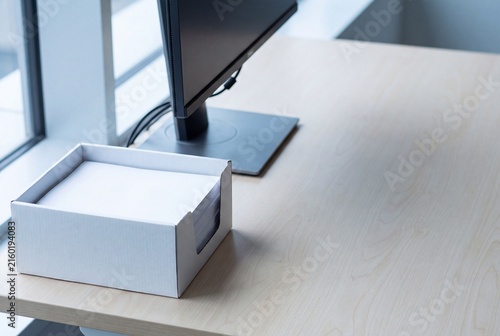 Paper recycling box beside a minimalist office desk