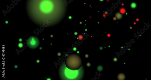 Glowing green and red bokeh lights floating and moving on black background motion design