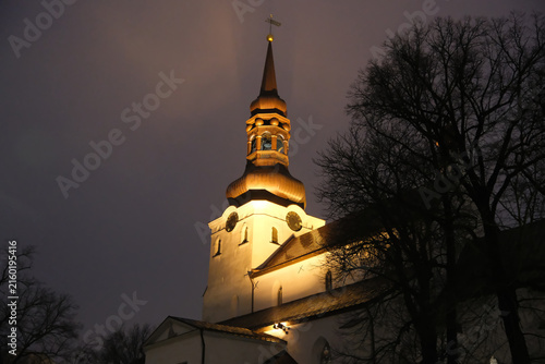 low-angle night view of the illuminated St. Mary's Cathedral in Tallinn with baroque spire