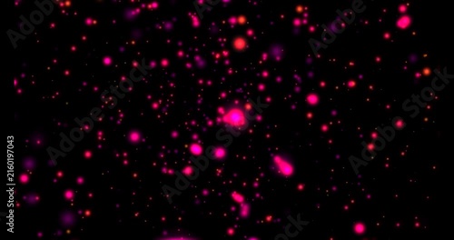 Bright pink and red glowing particles floating and drifting in dark space background