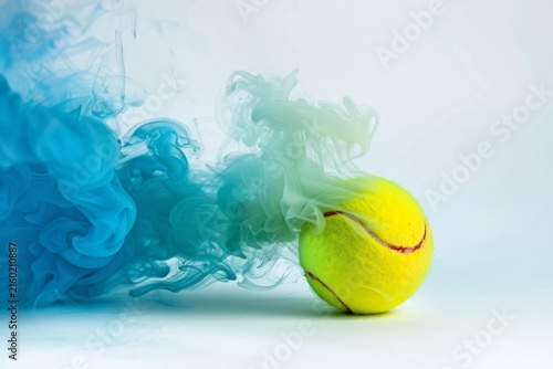 Yellow tennis ball creating a colorful smoke cloud effect on a minimalist white background