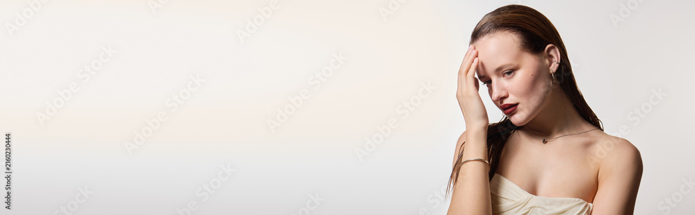 Fototapeta premium Beautiful young woman showcasing chic elegance in serene atmosphere