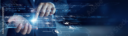 Compliance chief officer handholds virtual screen displaying futuristic data and touches Data Privacy system controls for advanced optimization. Innovative digital security infrastructure.