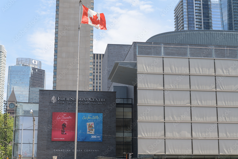 Fototapeta premium flag of Canada and view of Four Seasons Centre for the Performing Arts located at 145 Queen St W, Toronto