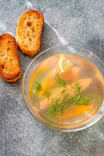Healthy Nordic Clear Salmon Soup With Fresh Dill Lemon And Vegetables In Glass Bowl
