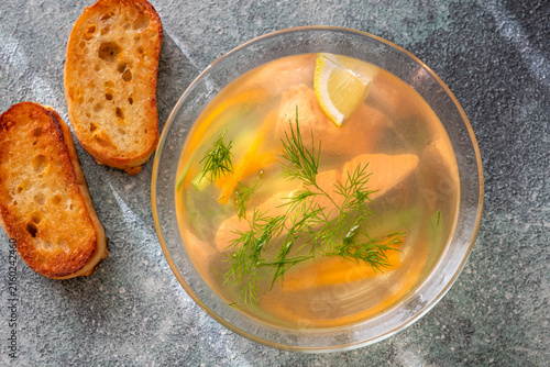 Healthy Nordic Clear Salmon Soup With Fresh Dill Lemon And Vegetables In Glass Bowl
