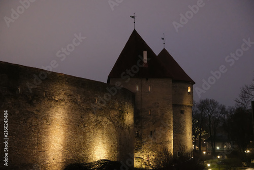 night view of illuminated Tallinn town wall and defensive towers at night