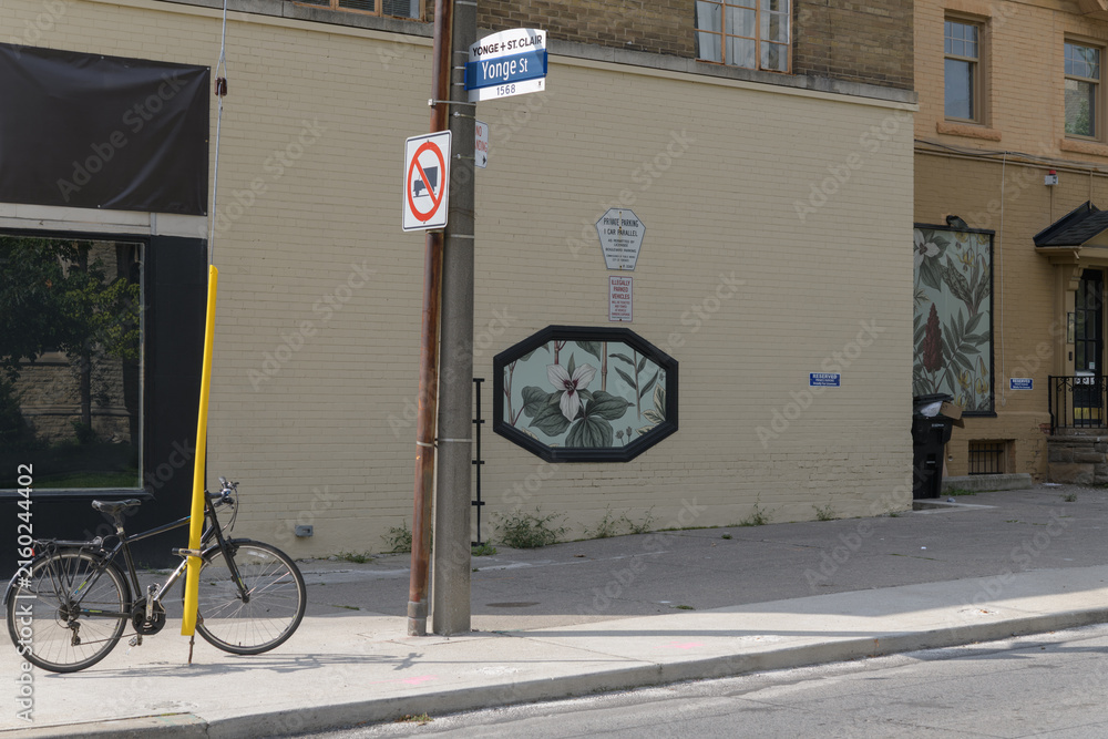 Naklejka premium historic brick building at 1566–1568 Yonge St - Heath St W, with bicycle in Toronto (site of planned Yonge/Heath intersection realignment)