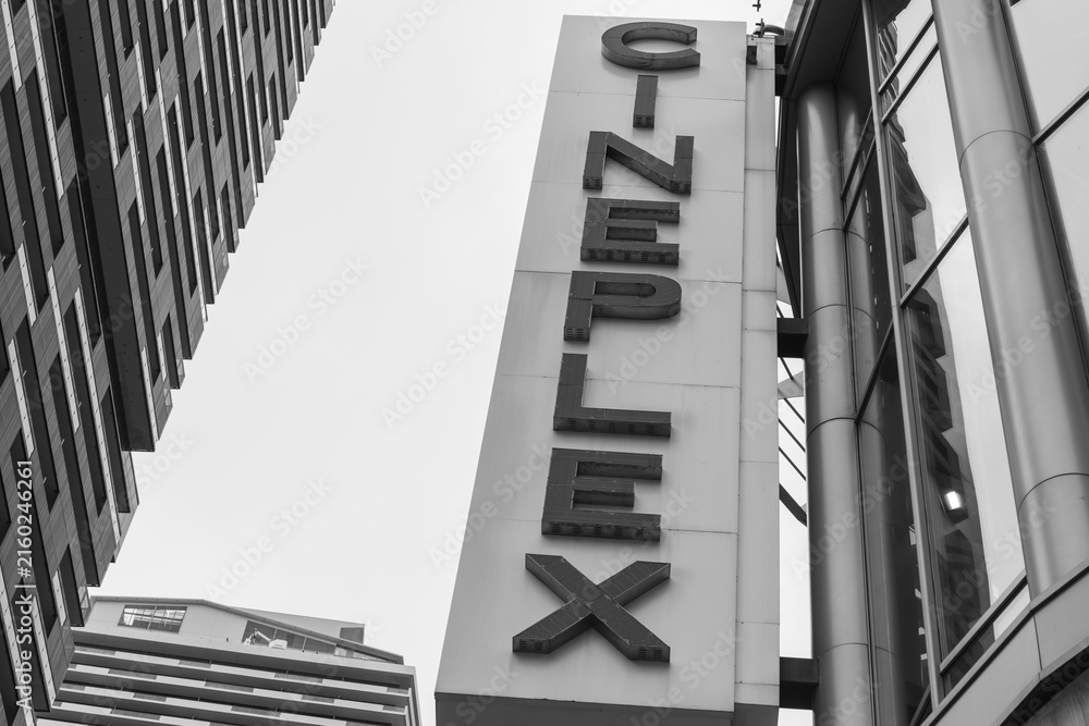 Fototapeta premium black and white upward view of projecting sign outside Cineplex Cinemas, a movie theatre complex, located at 2300 Yonge St (Yonge Eglinton Centre), Toronto