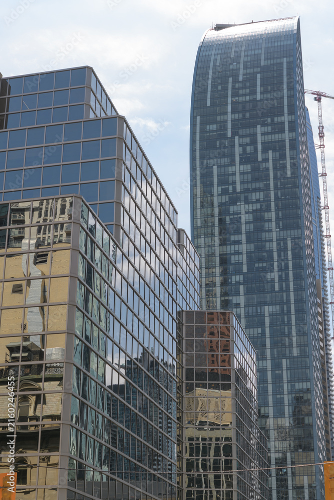 Fototapeta premium perspectival view of Berczy Square (33 Yonge St) and L-Tower, Daniel Libeskind's sculptural residential tower at 8 The Esplanade, Toronto