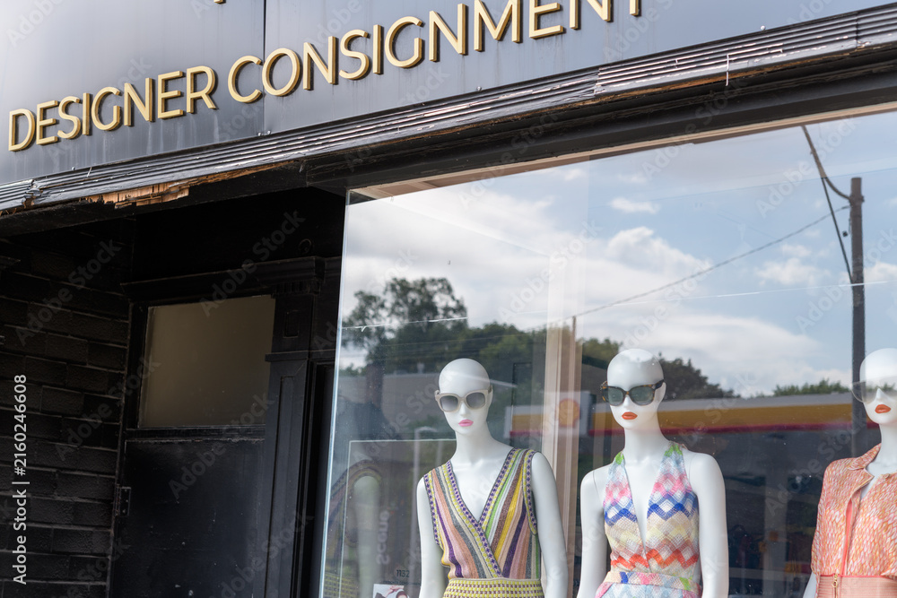 Fototapeta premium mannequins with sunglasses red lip stick and summer dresses inside shop window at 1132 Consignment, 1132 Yonge St, Toronto