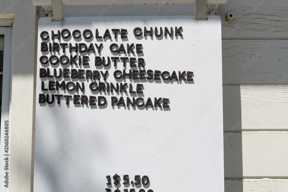 Obraz premium cookie menu (chocolate chunk, birthday cake, cookie butter, blueberry cheesecake, lemon crinkle, buttered pancake) outside Andrea's Cookies, a cookie shop, located here at 1632 Bloor St W, Toronto