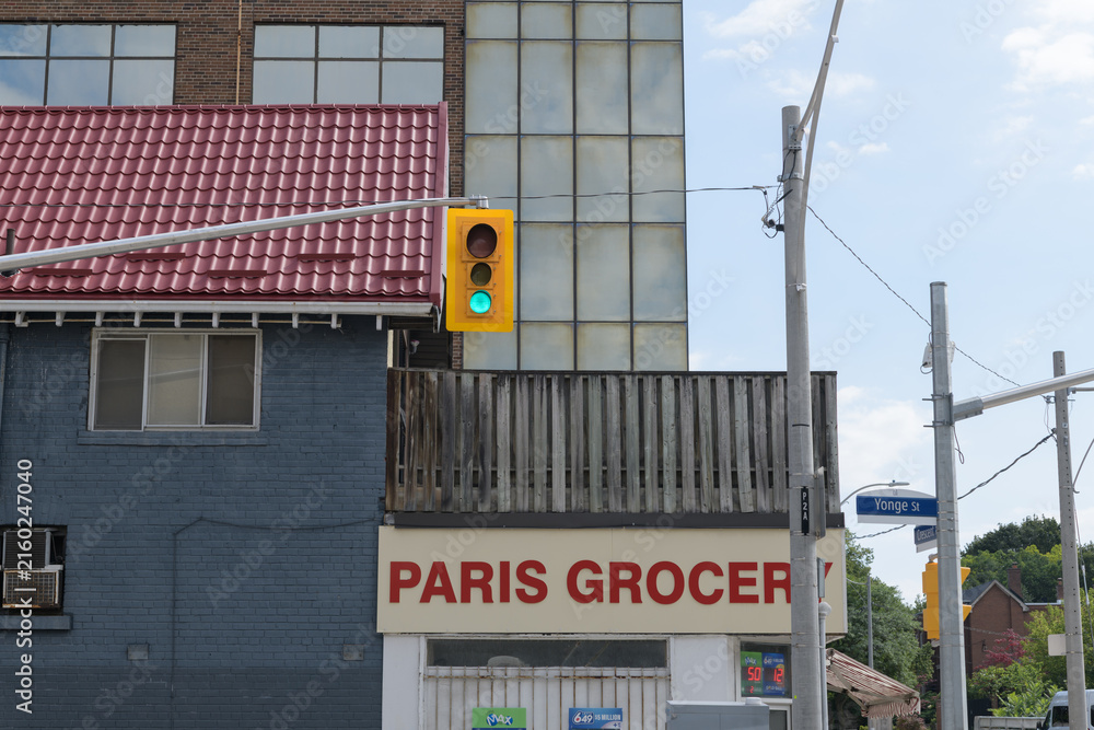Fototapeta premium exterior building surfaces including sign of Paris Grocery located at the northeast corner of 2 Crescent Rd and Yonge St, Toronto