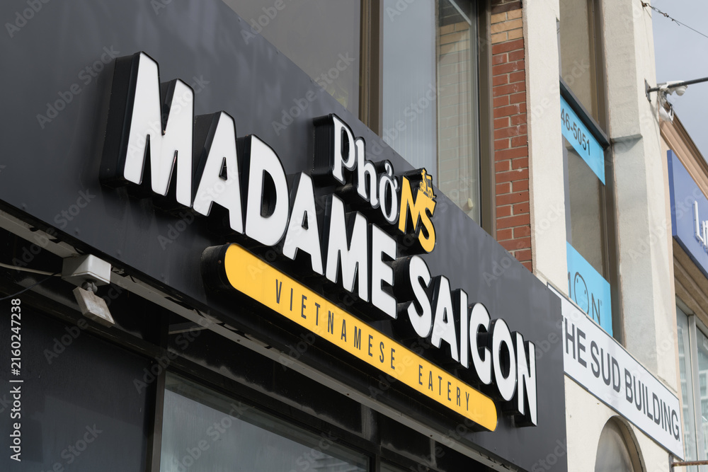 Fototapeta premium exterior building facade and sign of Madame Saigon, a Vietnamese restaurant, located at 2038 Yonge St, Toronto