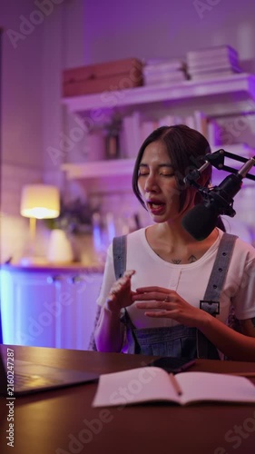 Asian influencer talking in broadcast on social media live on Laptop and smartphone recording online,greeting listeners with coaching life,Stratagem or business at modern home studio.broadcast concept