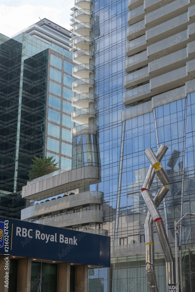 Fototapeta premium wide view of intersection at Yonge and Bloor (RBC Royal Bank at 2 Bloor St E) with view of Ron Arad sculpture, 