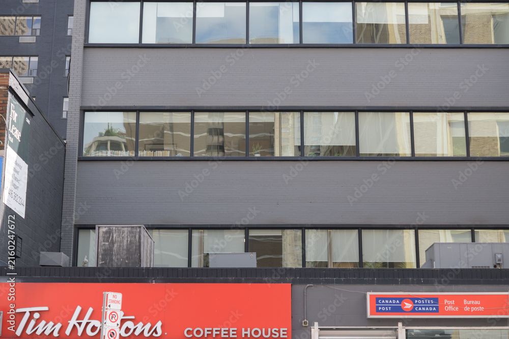 Fototapeta premium Tim Hortons coffee shop and Canada Post office on Yonge St, Toronto
