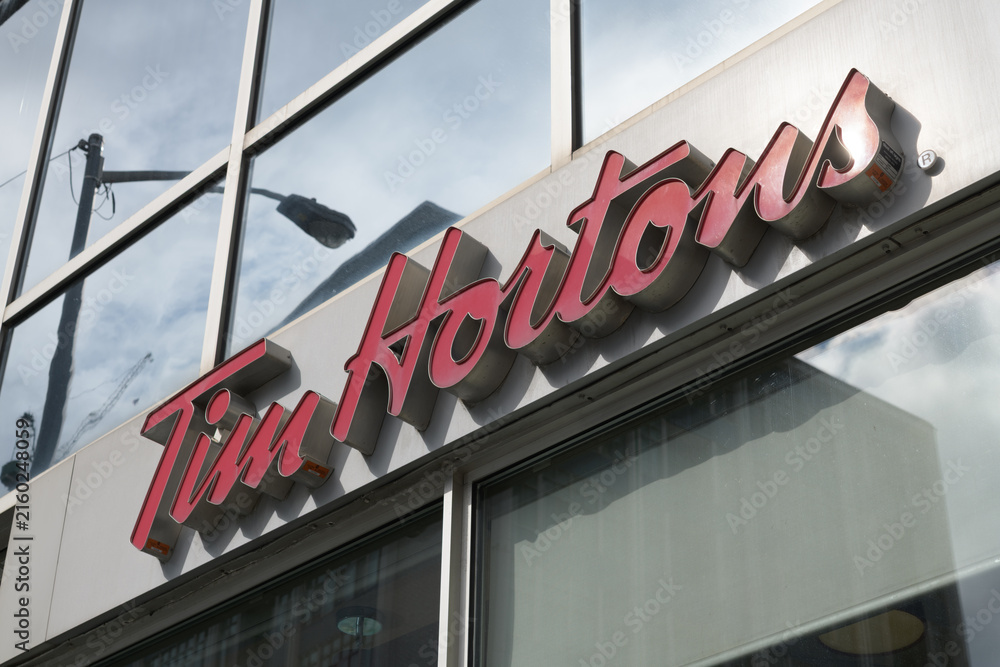 Naklejka premium exterior building facade and sign of Tim Hortons, a coffee shop chain, located here at 1910 Yonge St inside Davisville Centre, Toronto
