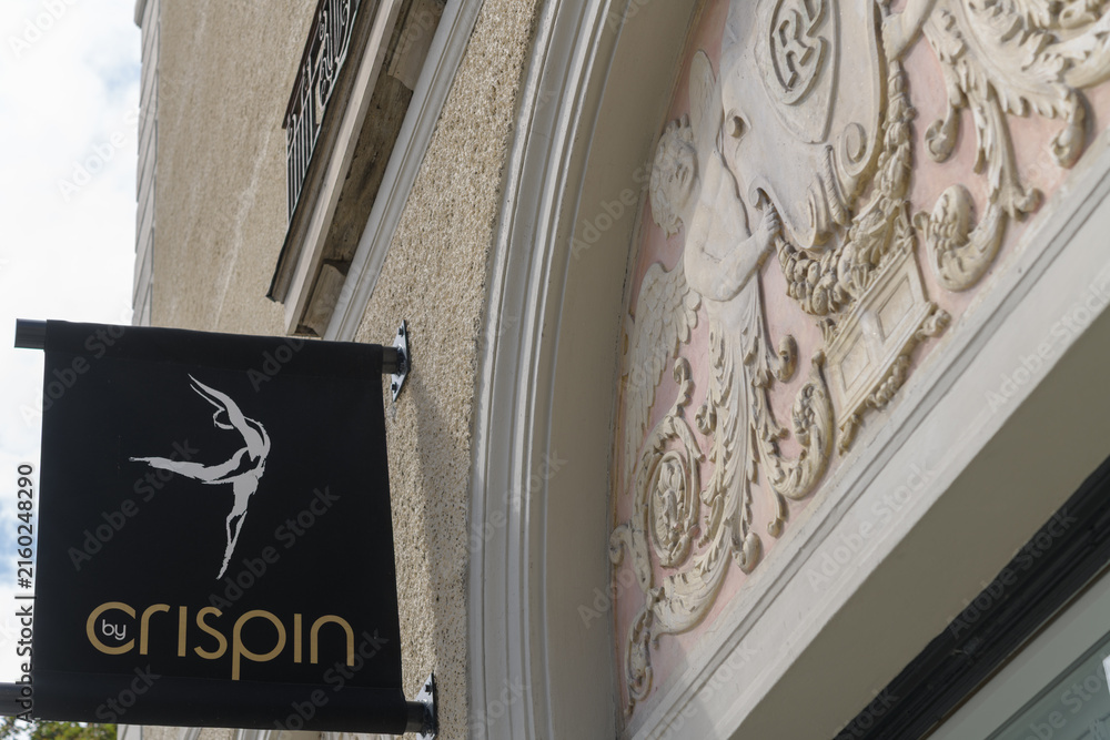 Fototapeta premium projecting sign of By Crispin, a gym, located outside a historic building at 1044 Yonge St, Toronto