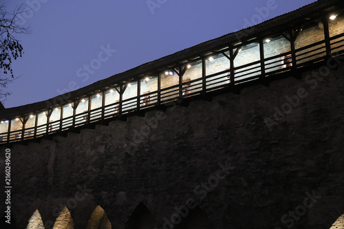 Low-angle dusk view of the wooden walkway atop Tallinn town wall 