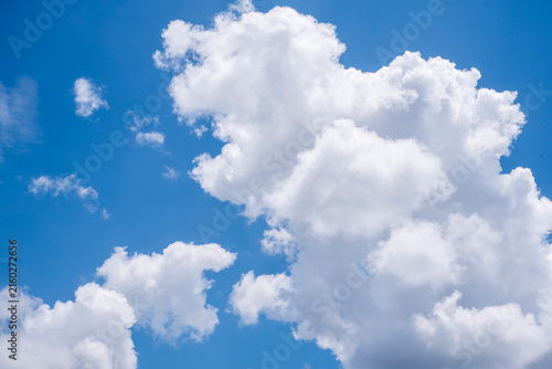 Konstfotografi Bright blue sky filled with large fluffy white cumulus clouds on a clear sunny day creating a fresh and vibrant cloudscape perfect as a natural background