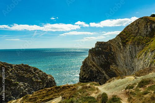 Bild auf Leinwand Rugged cliffs overlooking the turquoise sea on the Jurassic Coast in Dorset, Eng