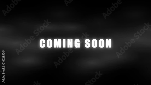 Coming soon cinematic text reveal with glowing light effects on dark smoky background