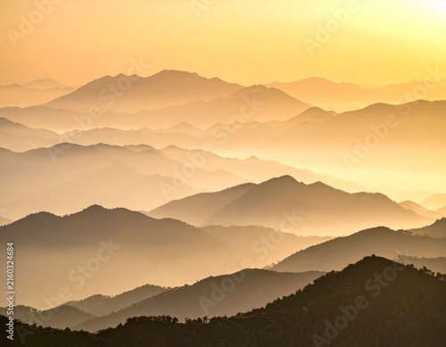 the sun sets over the mountains in the mountains