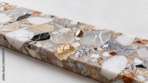Close-up view of a decorative stone slab featuring various mineral patterns and textures, showcasing a mix of white, gray, and gold hues on a smooth surface