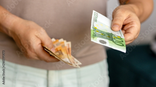 Quadro su tela Hand giving one hundred euro banknote