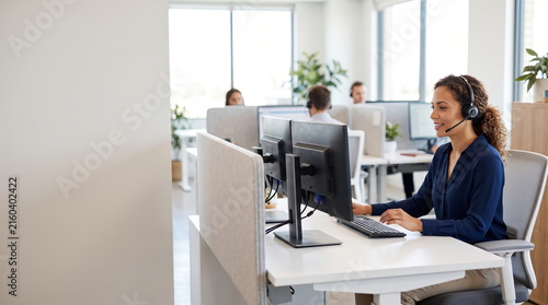 Customer service representative assisting clients in a call center environment