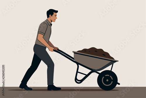 Hardworking young man pushing a heavy metal wheelbarrow filled with dark organic soil for a gardening project.