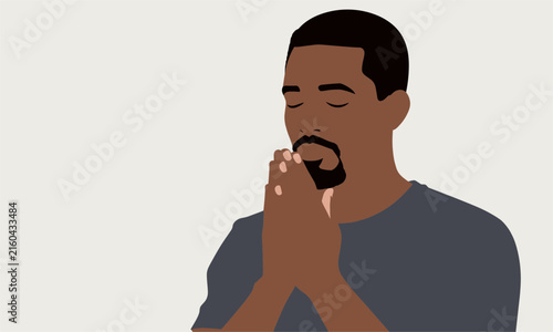 Sincere man of color with closed eyes clasps his hands together in deep prayer, meditation, or quiet contemplation.