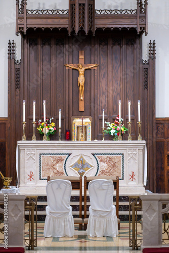 Interior view of church sanctuary with altar and pews during wedding ceremony