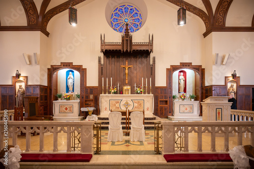Bild auf Leinwand Interior view of traditional church altar with crucifix and stained glass window