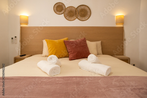 Luxury hotel style bedroom with decorative pillows and towels