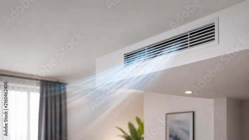 Ducted ceiling air conditioning vent blowing cool air into a modern living room interior
