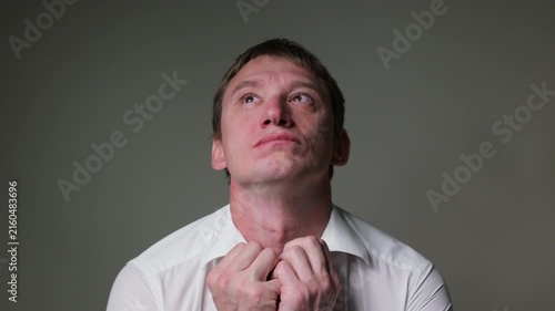 Businessman in a white t-shirt  with a sad and disappointed facial expression. Studio portrait isolated on a white background, suitable for business, stress andal concepts.