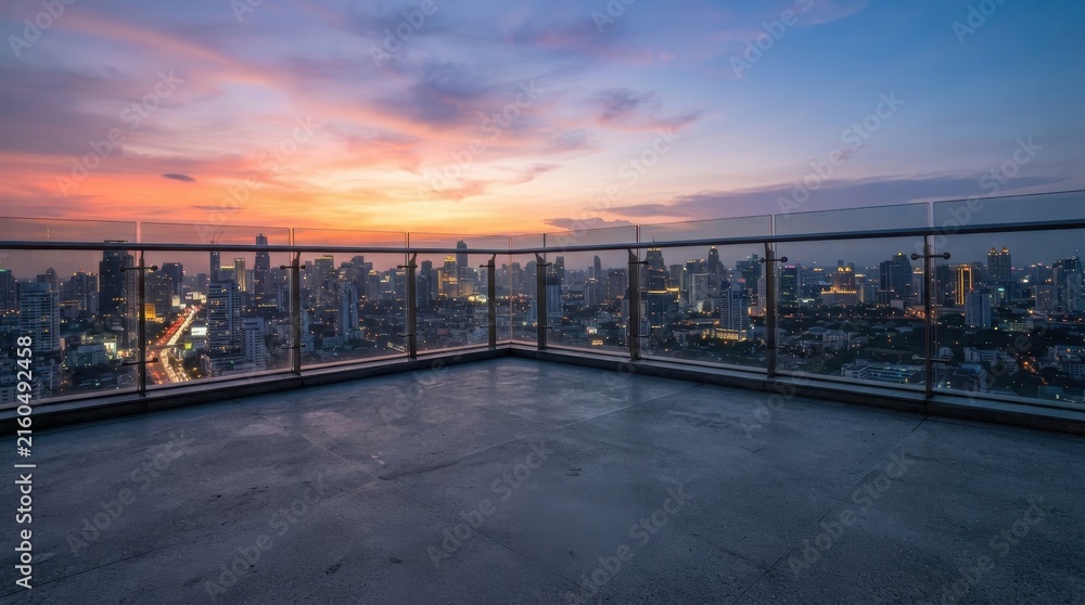 Fototapeta premium Rooftop terrace overlooking city skyline at sunset