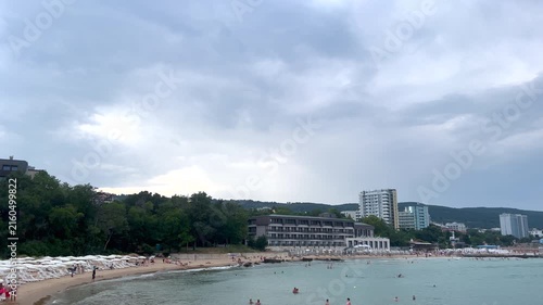 Stormy clouds gathering over a crowded beach