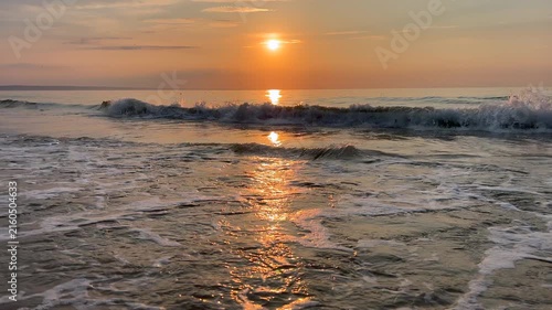 Golden sun reflecting on calm ocean waves