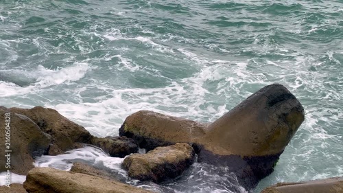 Rough ocean waves crashing against coastal breakwaters