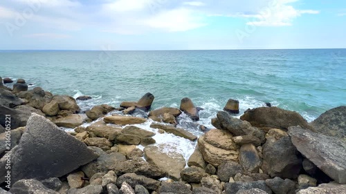 Rocky seashore with ocean waves crashing