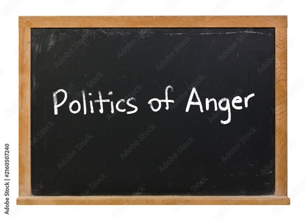 Fototapeta premium Politics of Anger written in white chalk on a black chalkboard isolated in a wooden frame on white