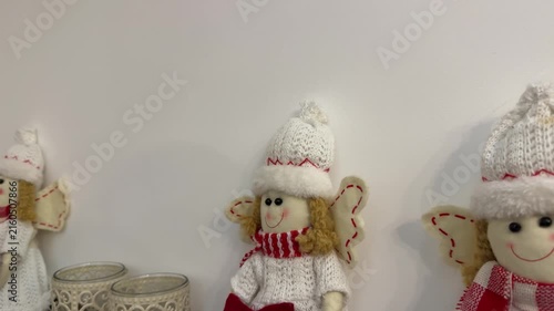 Three knitted angel dolls revealed by camera pullback, cozy Christmas holiday decor