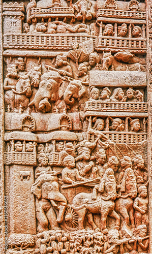 Buddhist narrative relief depicting a royal procession with elephants, horse-drawn chariot, attendants, and multi-storied palace architecture, from the Great Stupa Torana at Sanchi, Sanchi, India