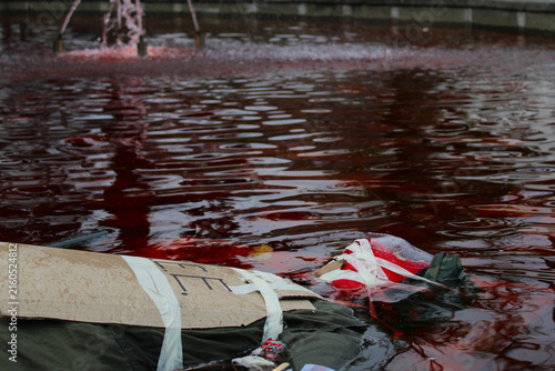 Foto Protest Dummy Floating in Red Dyed Water Fountain Conceptualizing Social Unrest