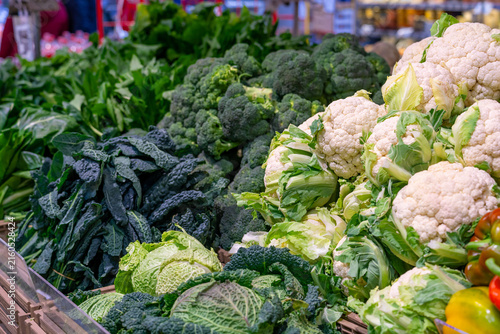 Fresh assortment of healthy green vegetables and cauliflower at a market stall