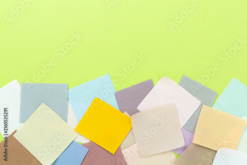 Fabric color samples on color background, top view